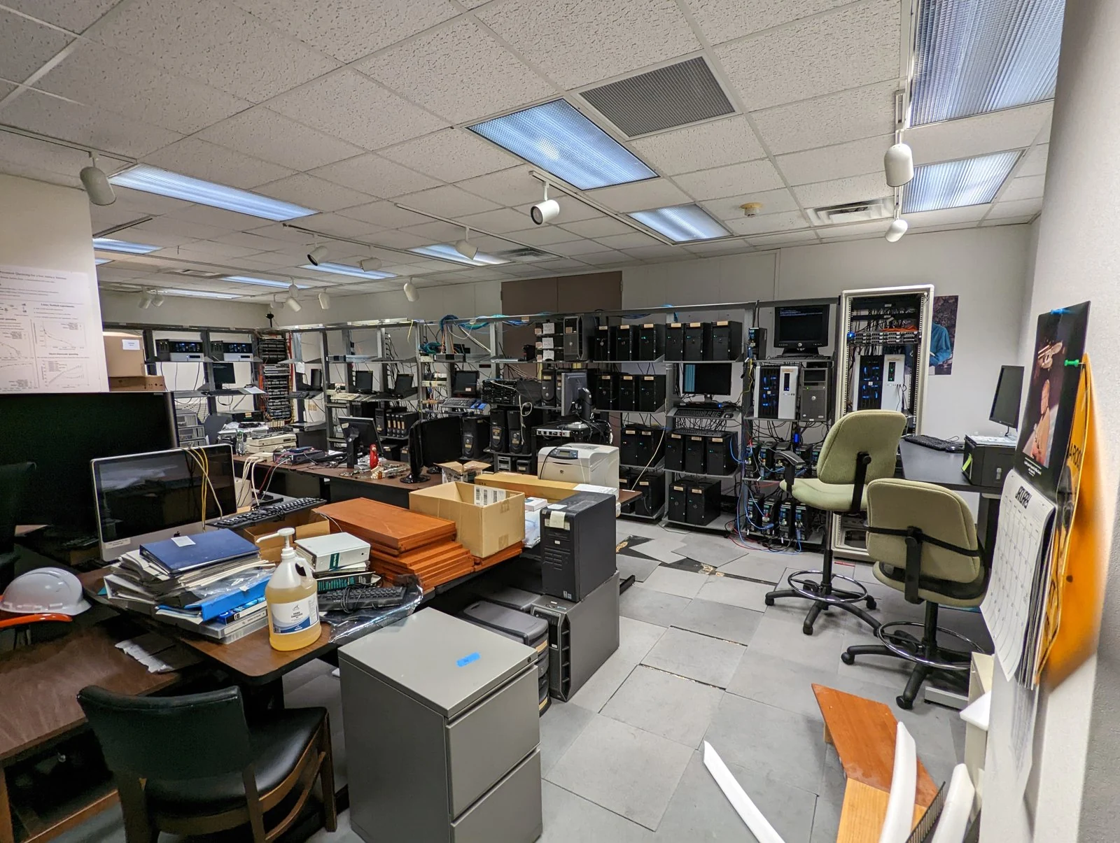 Sitterson 156 before renovation, with computer racks, stored equipment and crowded worktables