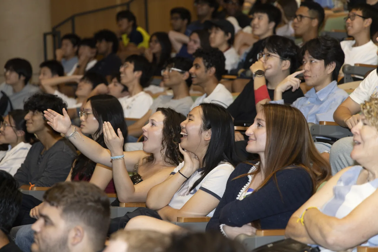 Audience members watching the race and reacting together